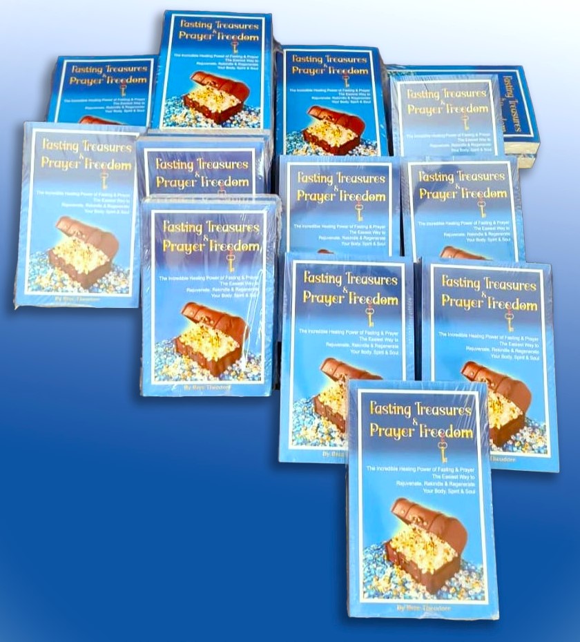 Many copies of the book Fasting Treasures & Prayer Freedom arranged on a blue background